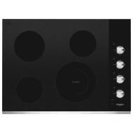 Black ceramic glass cooktop with four radiant cooking zones and metallic control knobs for kitchen appliances and home improvement