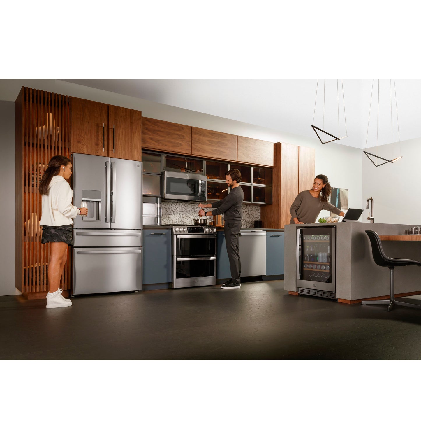 Contemporary kitchen with stainless steel appliances including refrigerator, double oven gas range, and beverage cooler in modern setting