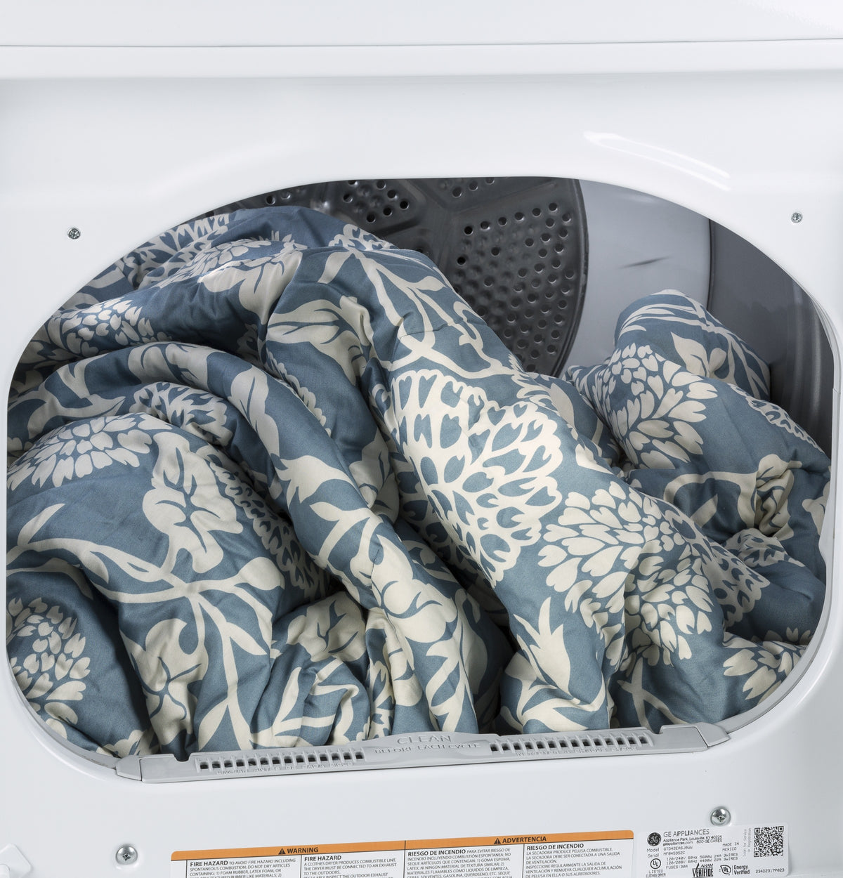 Blue and white floral comforter inside aluminized alloy drum of electric dryer from Dryers and Appliances collection