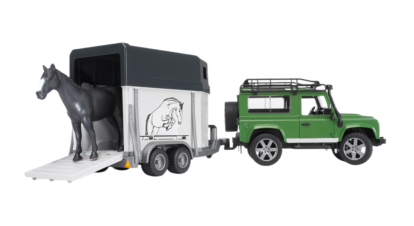 Green Land Rover Defender toy towing a white horse trailer with a black horse figure and ramp lowered