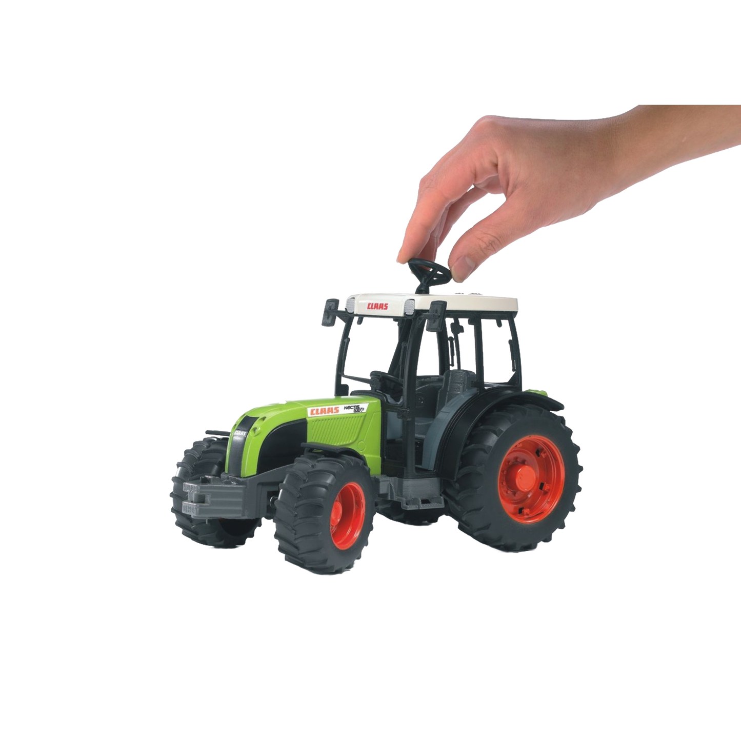 Hand placing black detachable weight on green and black Bruder Claas Nectis 267 F Tractor toy from Vehicles & Remote Controlled Toys collection
