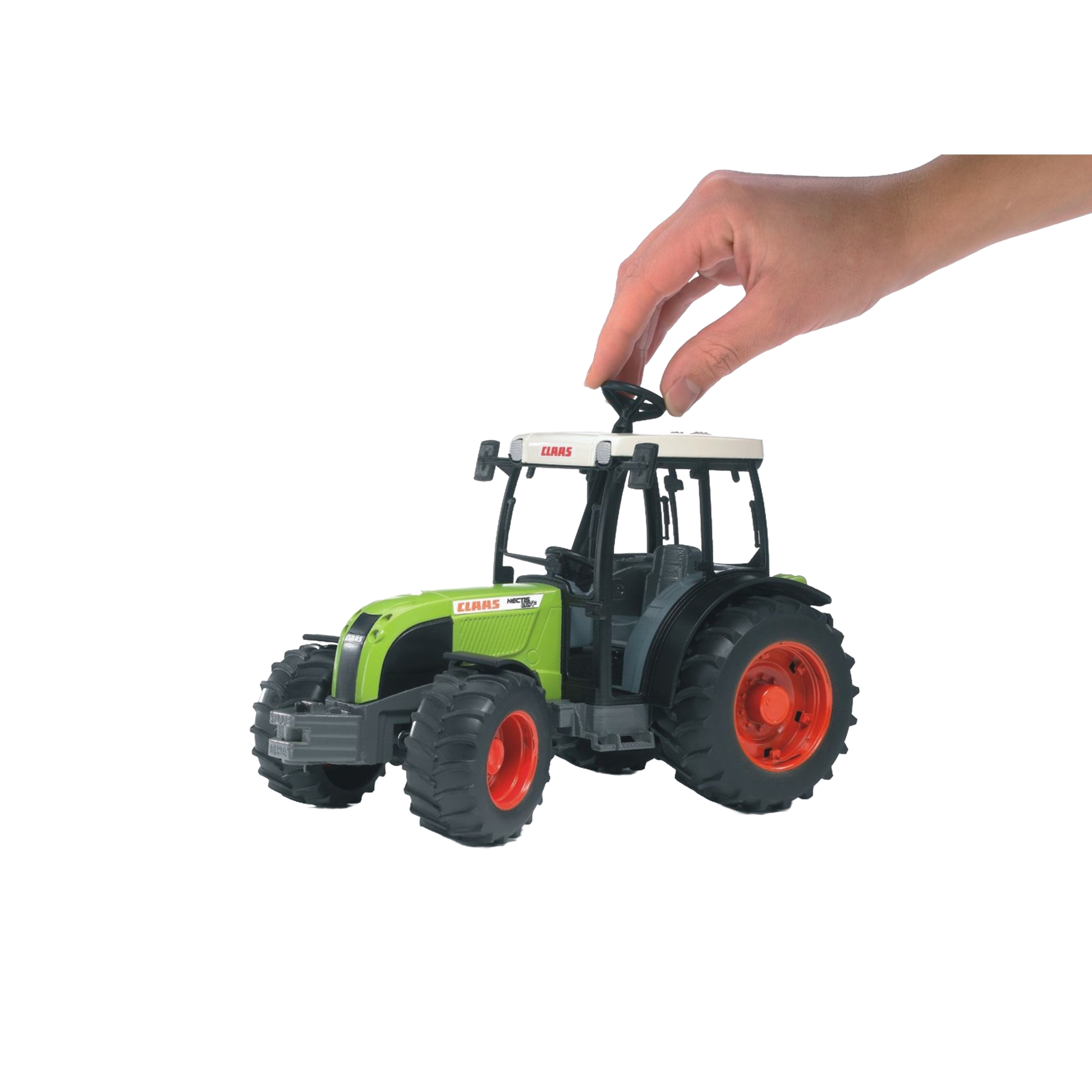 Hand placing black detachable weight on green and black Bruder Claas Nectis 267 F Tractor toy from Vehicles & Remote Controlled Toys collection