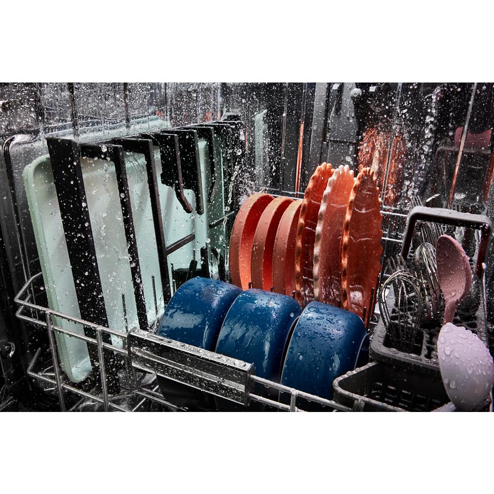 Open dishwasher loaded with wet plates, bowls, utensils, and kitchenware after cleaning cycle for home improvement tools