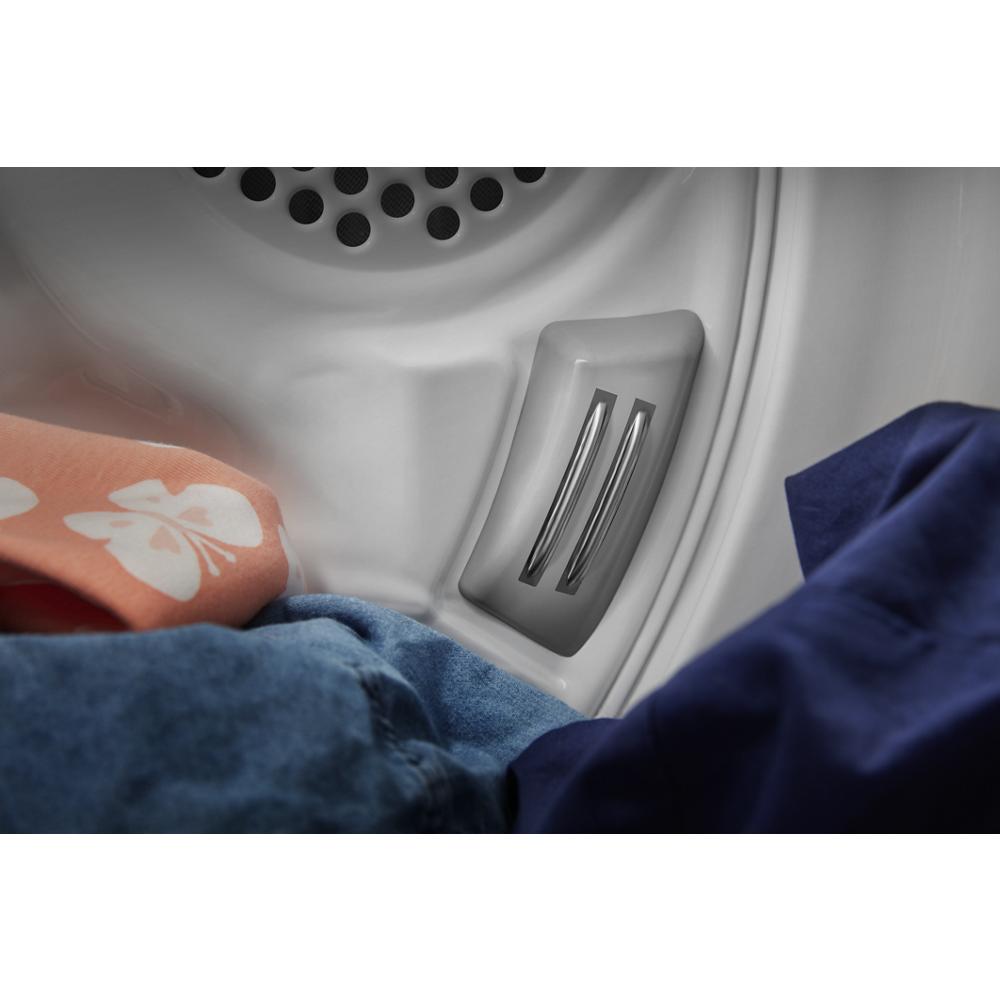 Close-up interior view of a gas dryer drum vent with clothes inside from dryers and appliances collection