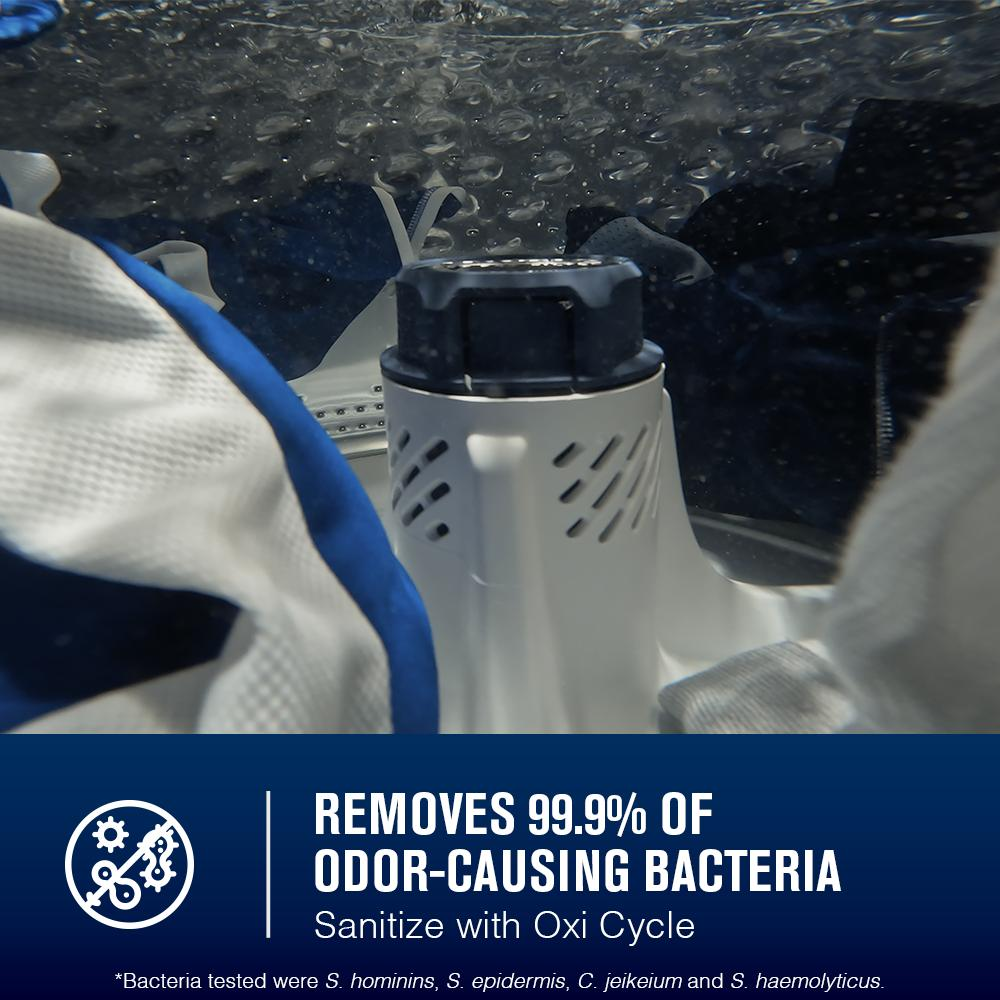 Close-up of washer impeller in water with fabric, highlighting bacteria removal and Oxi sanitize cycle feature