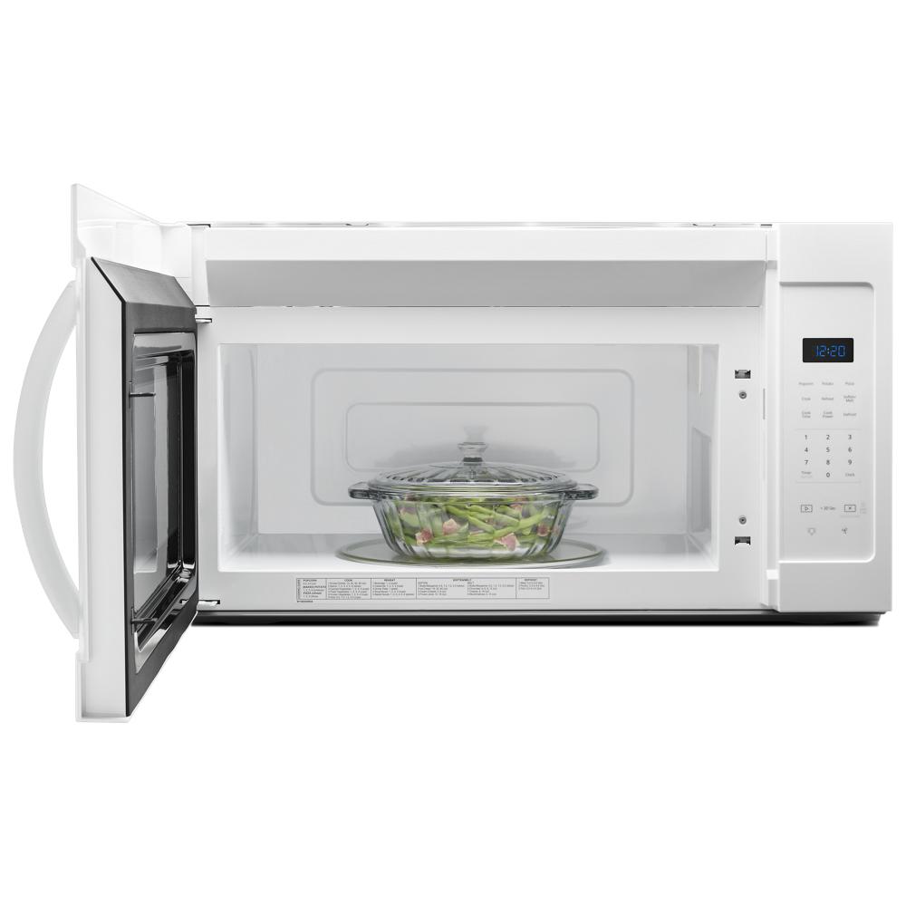 White over-the-range microwave with open door, glass casserole dish inside, and digital touch controls lit on timer