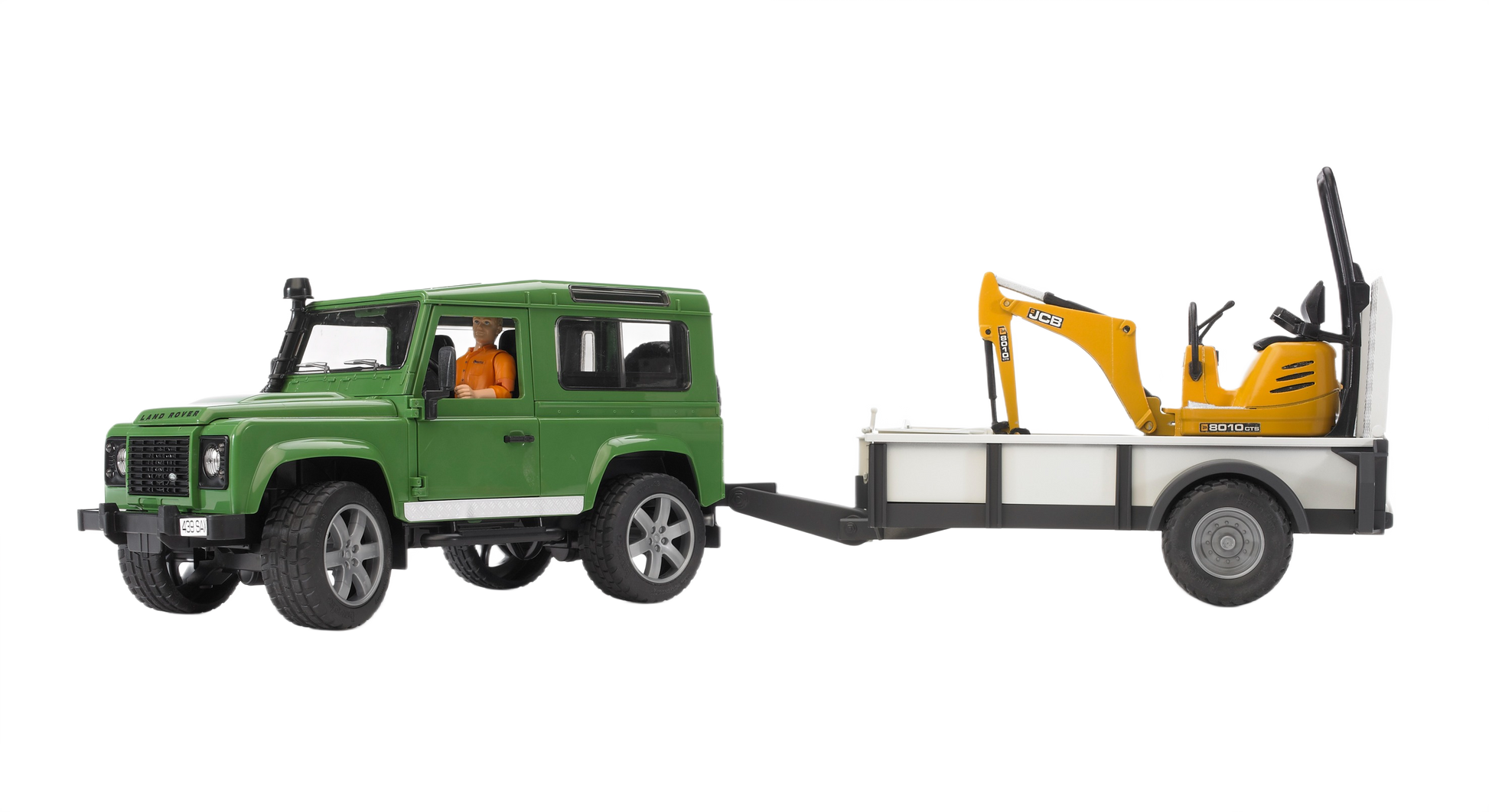 Green toy Land Rover Defender pulling trailer with detailed yellow JCB micro excavator from Bruder Toys collection