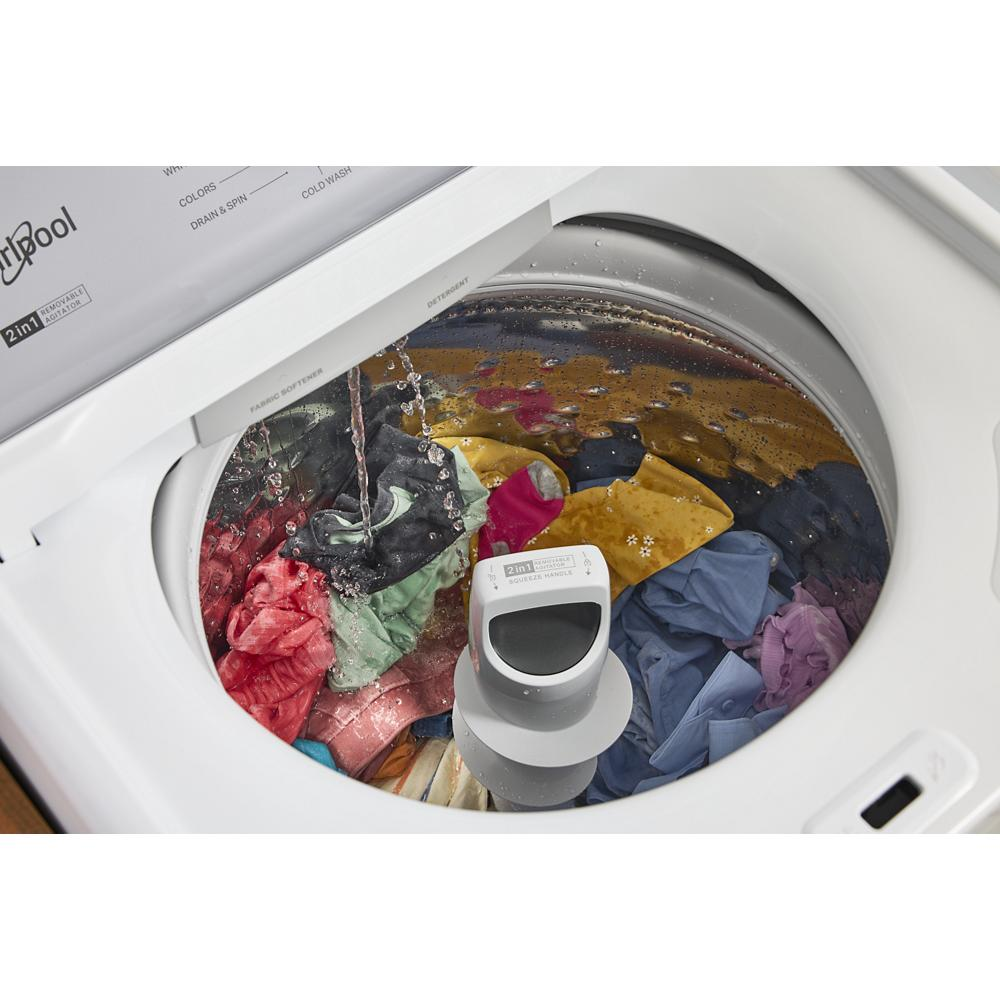 Top load washer filling with water over colorful clothes and 2-in-1 removable agitator in washing cycle
