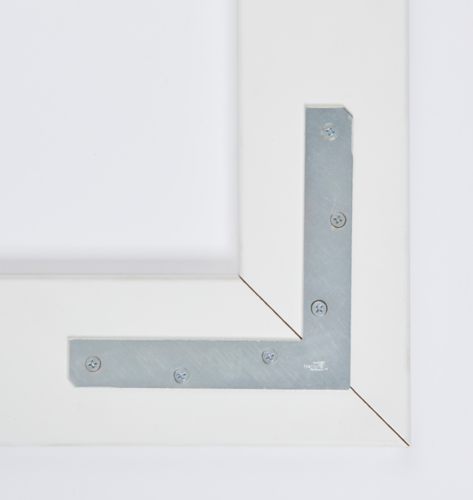 Zinc flat corner iron secured with screws on wood frame for reinforcement in building hardware and lumber materials collections