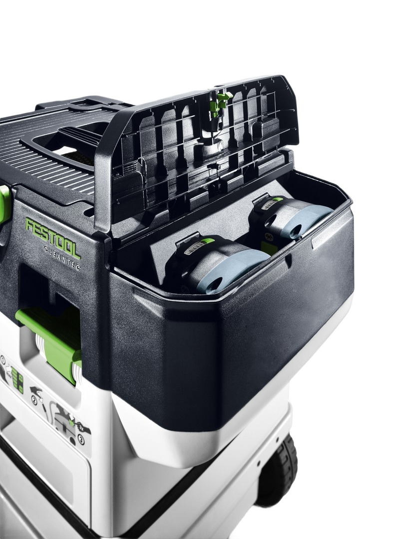 Open cordless dust extractor storage compartment showing two batteries in Festool mobile unit