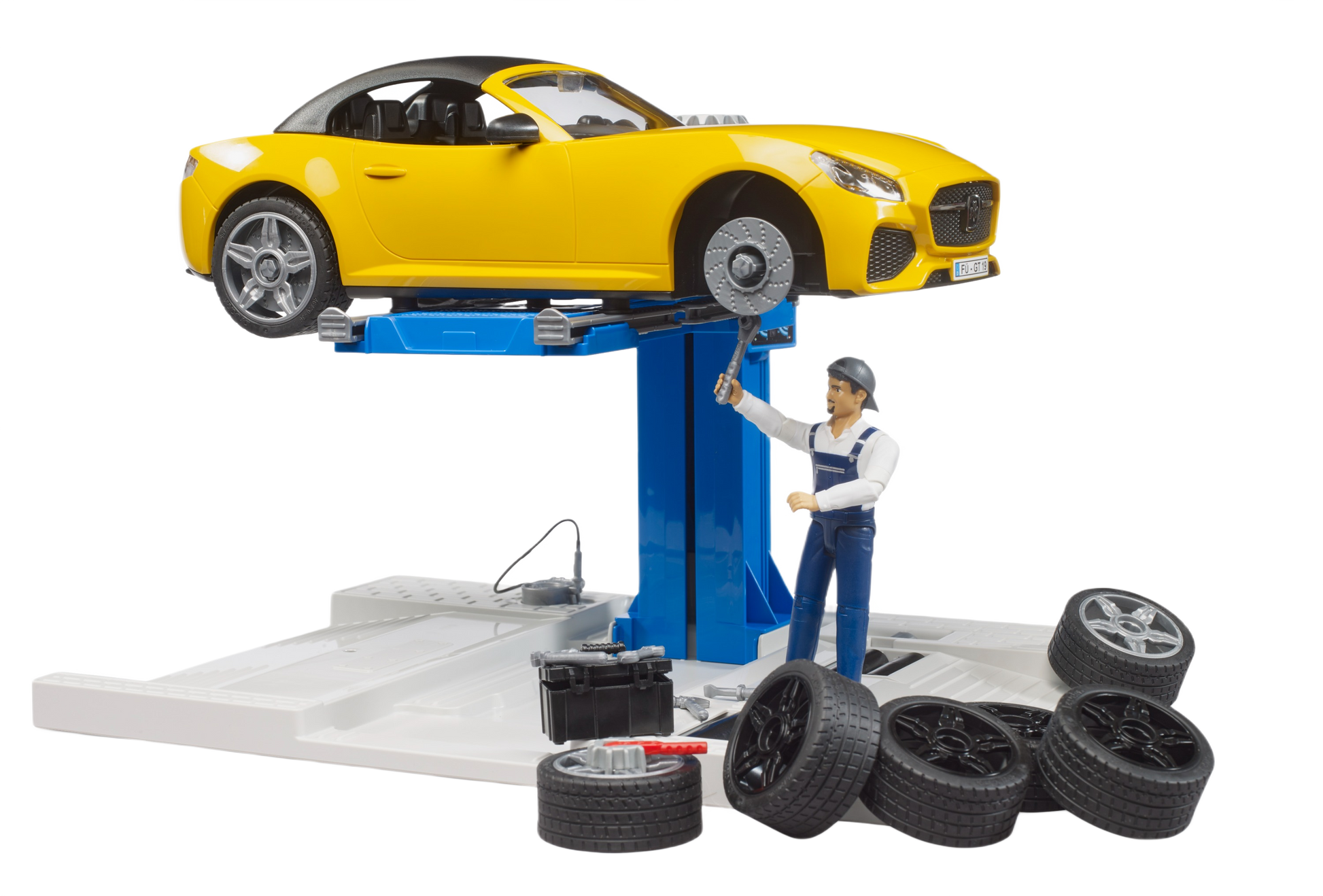 Yellow roadster toy elevated on blue car lift with mechanic figure, spare tires, and tool kit in car service playset
