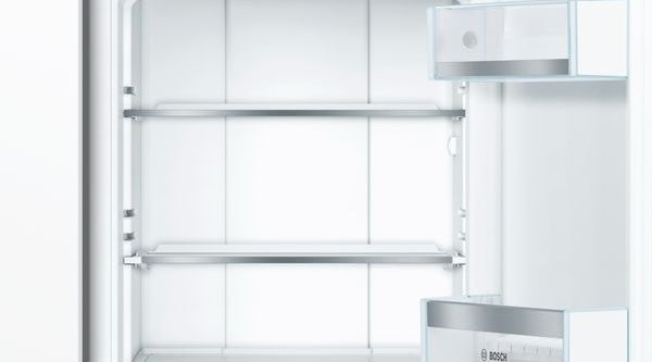 open white built-in refrigerator with adjustable glass shelves and door storage in Bosch kitchen appliances collection