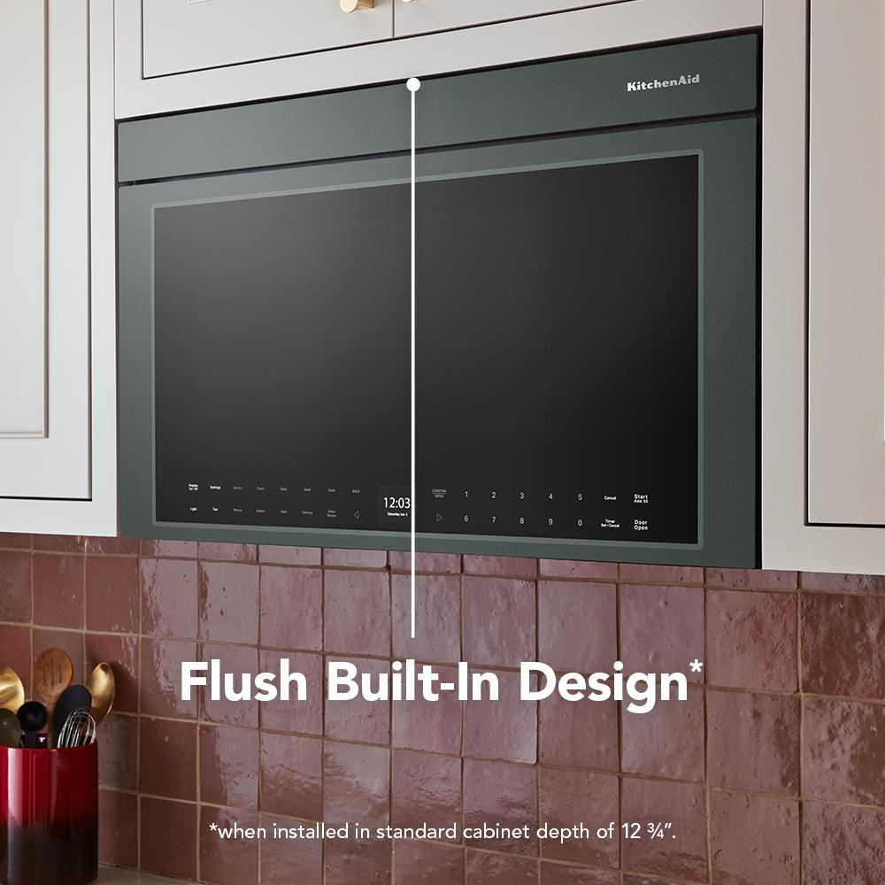 KitchenAid sleek black multifunction over-the-range microwave installed flush with white cabinetry in modern kitchen