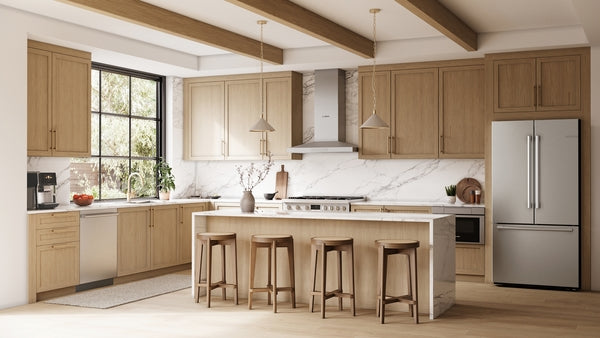 Modern kitchen with light wood cabinetry, marble island, stainless steel dishwasher and refrigerator, and natural light from window