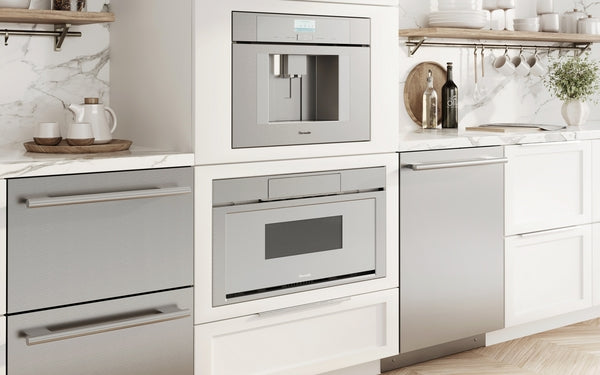 Built-in stainless steel microwave drawer and coffee system integrated into white kitchen cabinetry for modern kitchens