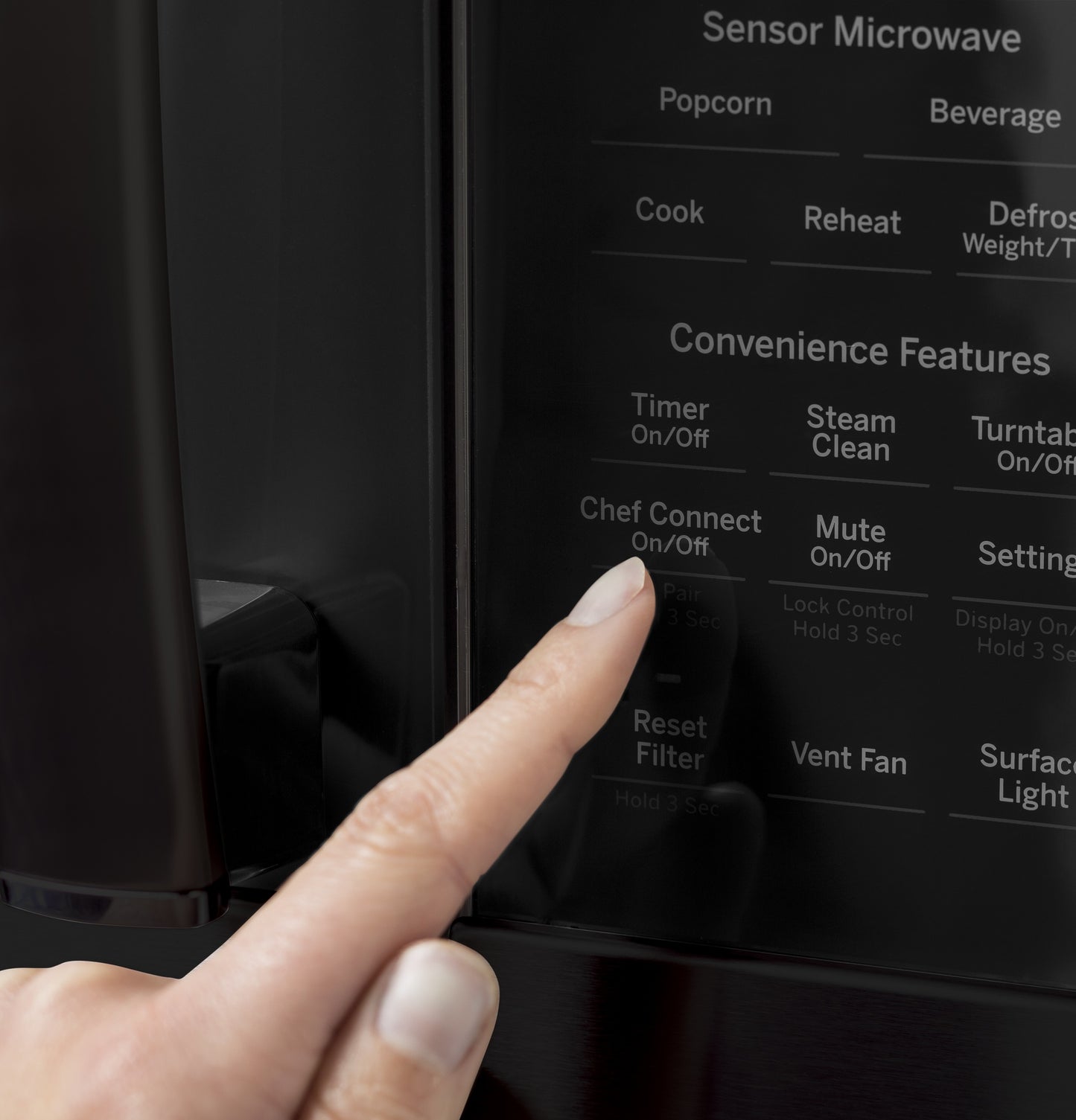 Finger pressing digital control panel featuring sensor cooking and convenience functions on black microwave from Microwaves collection