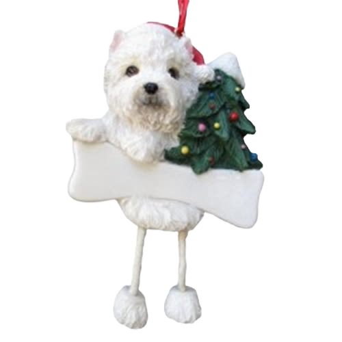 White Westie dog ornament wearing a Santa hat holding a Christmas tree with dangling legs for holiday decoration