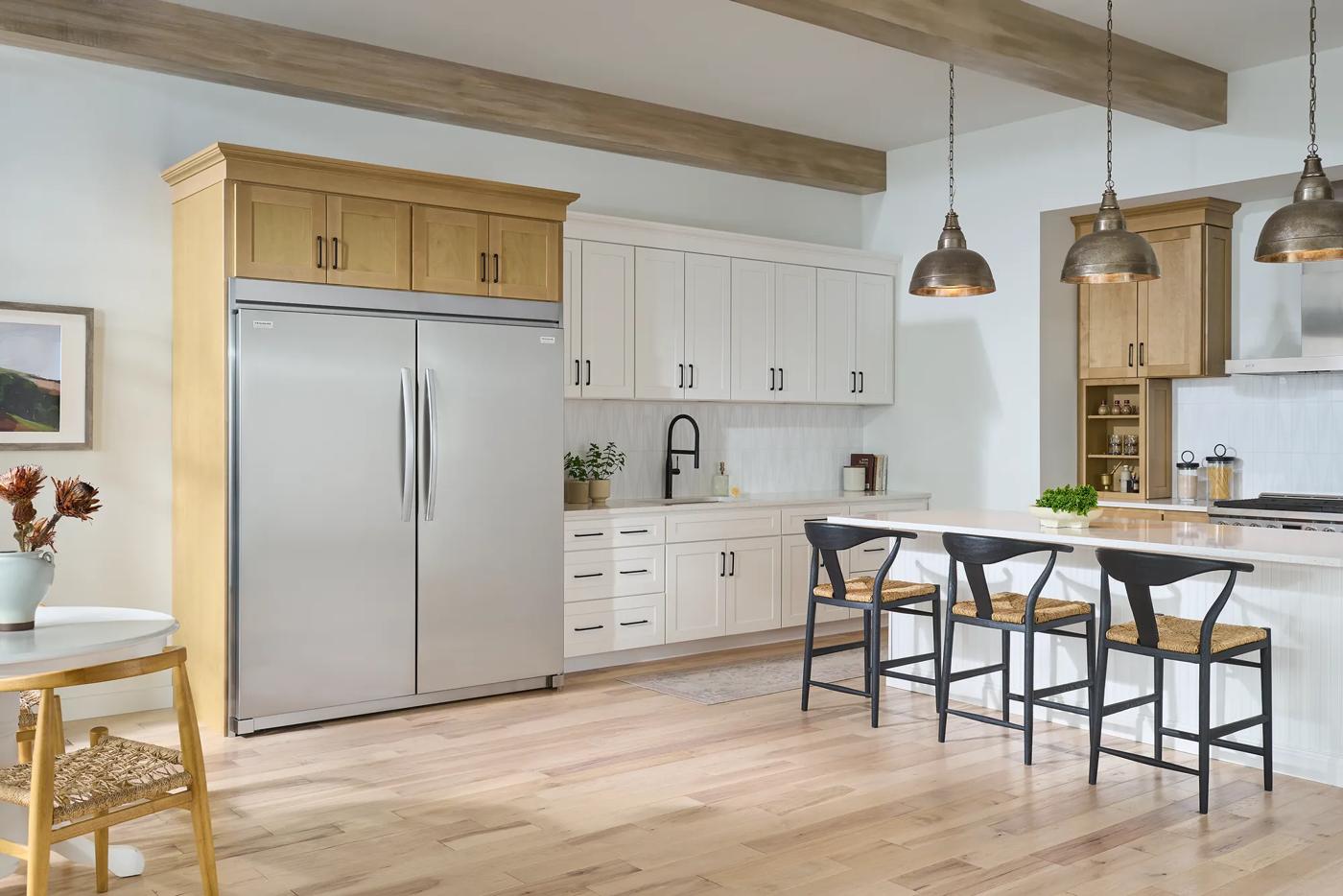 Modern kitchen featuring a large stainless steel double-door freezer integrated with wood cabinetry, part of upright freezers and kitchen appliance collections.