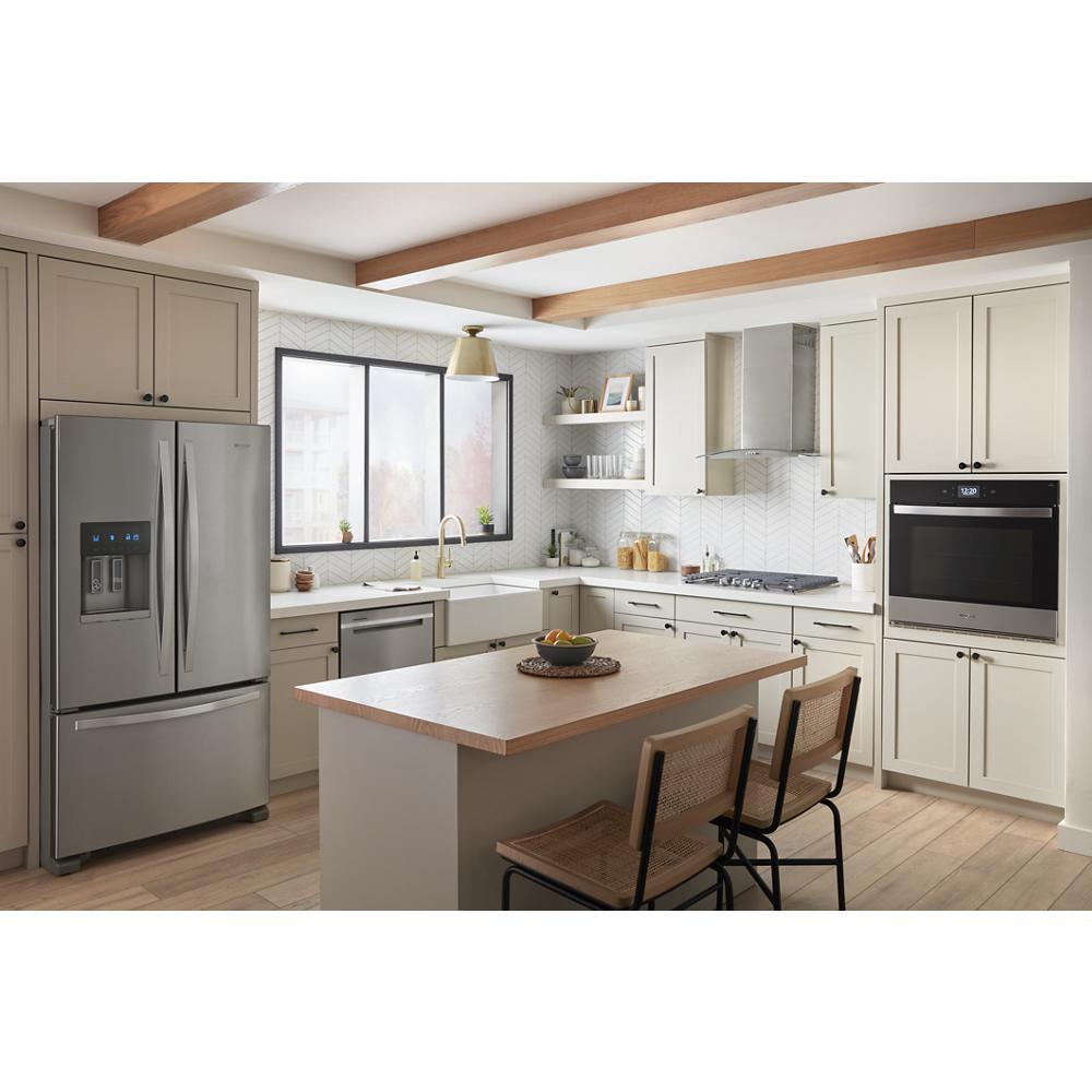 Modern kitchen featuring stainless steel single smart wall oven and French-door refrigerator in Appliances collection