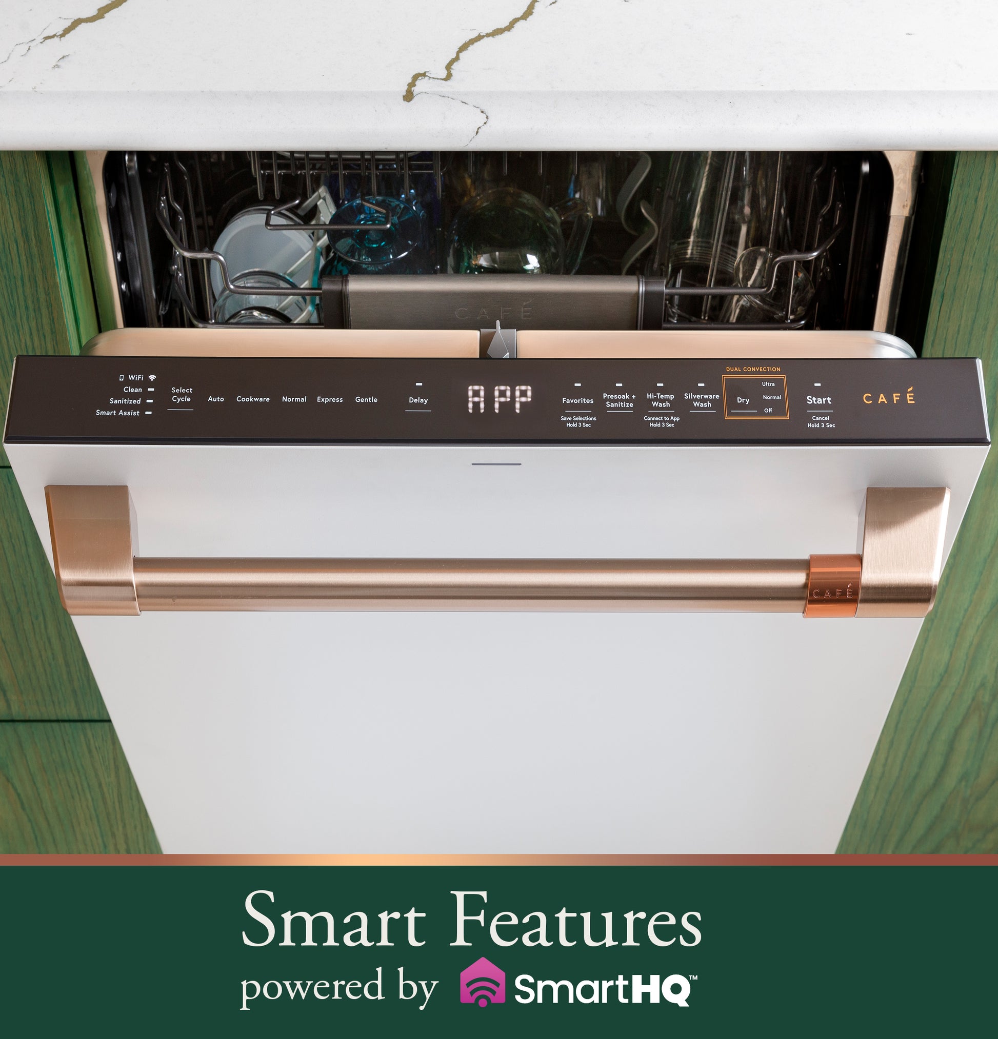 Front view of smart stainless steel dishwasher with copper-tone handle open under marble countertop in kitchenware collection