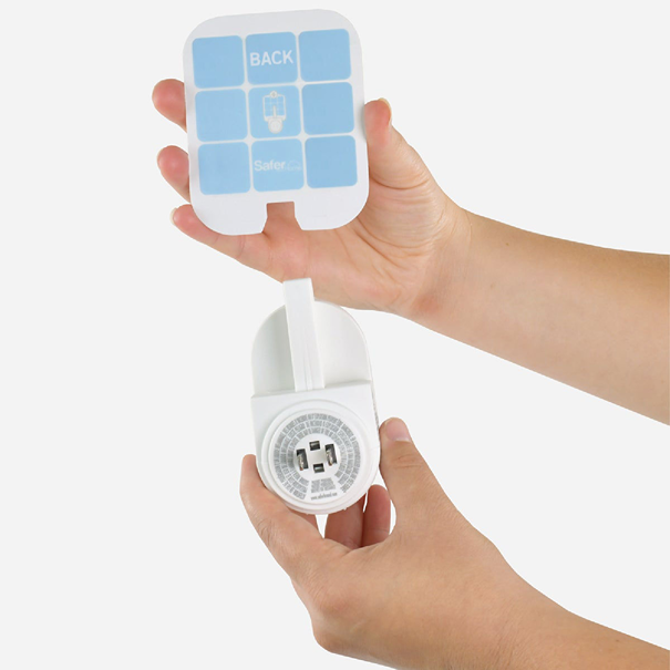 Person holding fly trap plug with removable adhesive card for indoor insect control under $50 category
