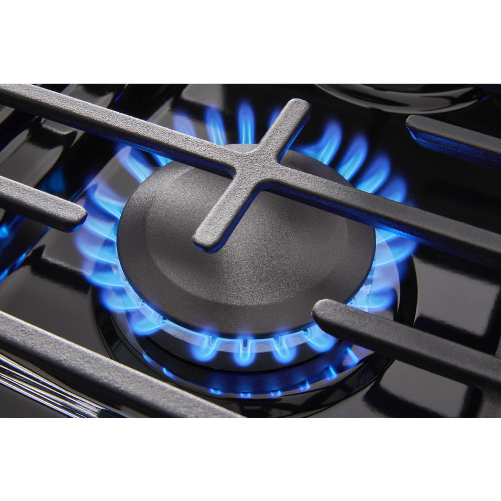 Close-up of a burning blue gas flame on a black 30-inch range burner from kitchen appliances collection