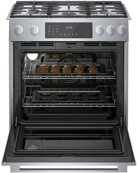 stainless steel dual fuel slide-in range with open oven and cookies baking in racks in kitchen appliances collection