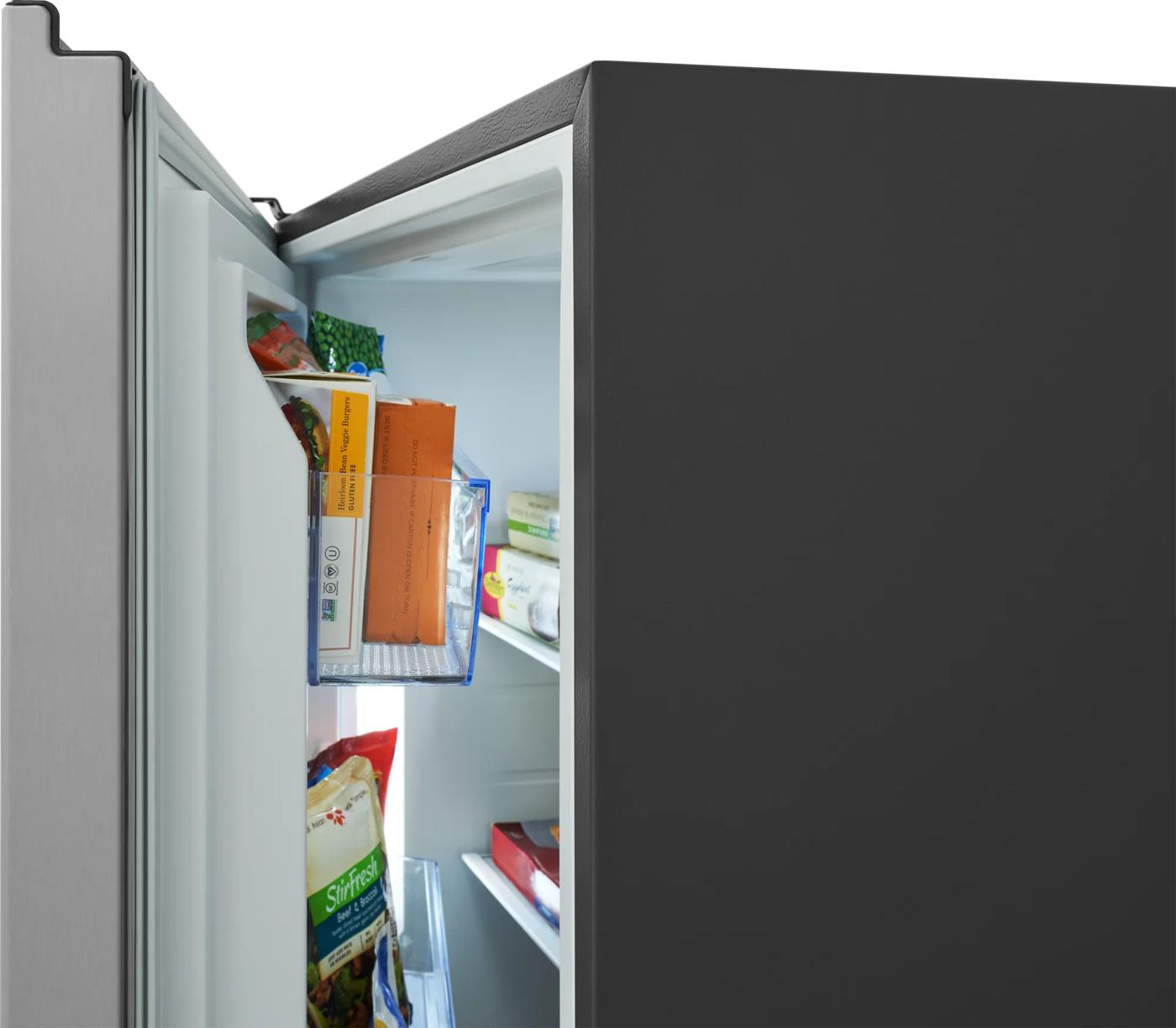 Partial side view of an open single-door freezer showing organized door shelves with frozen food bags, ideal for Upright Freezers and Appliances collections.