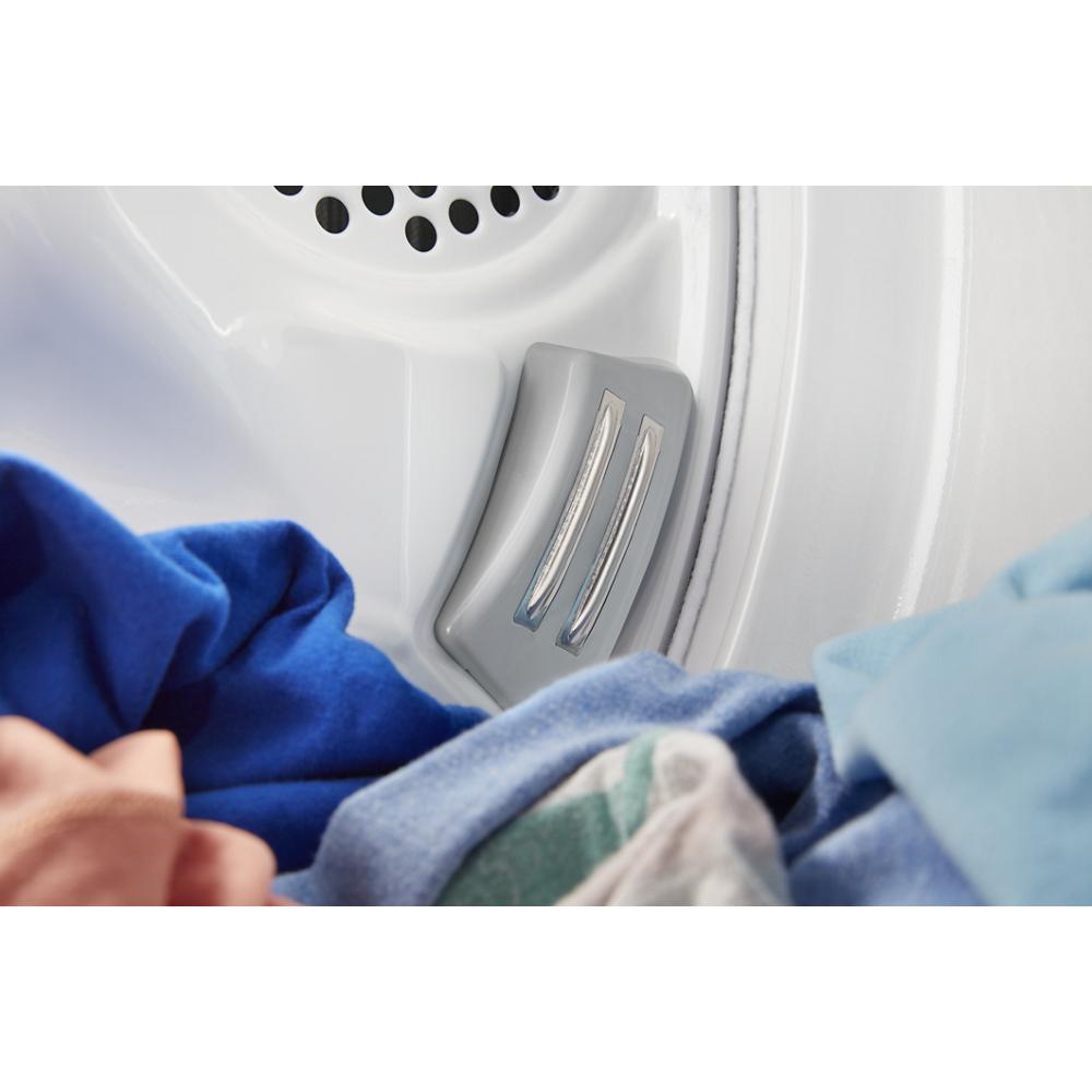 Close-up of pet hair removal feature inside white electric dryer drum with colorful clothes in Dryers collection