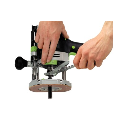 Hands holding a Festool router with ergonomic grip for accurate trimming in woodworking and home improvement tasks