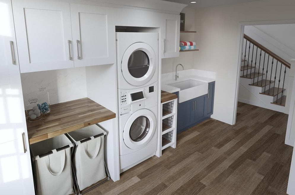 White stack washer and dryer combo with digital control panel in modern laundry room featuring wood countertops and cabinetry