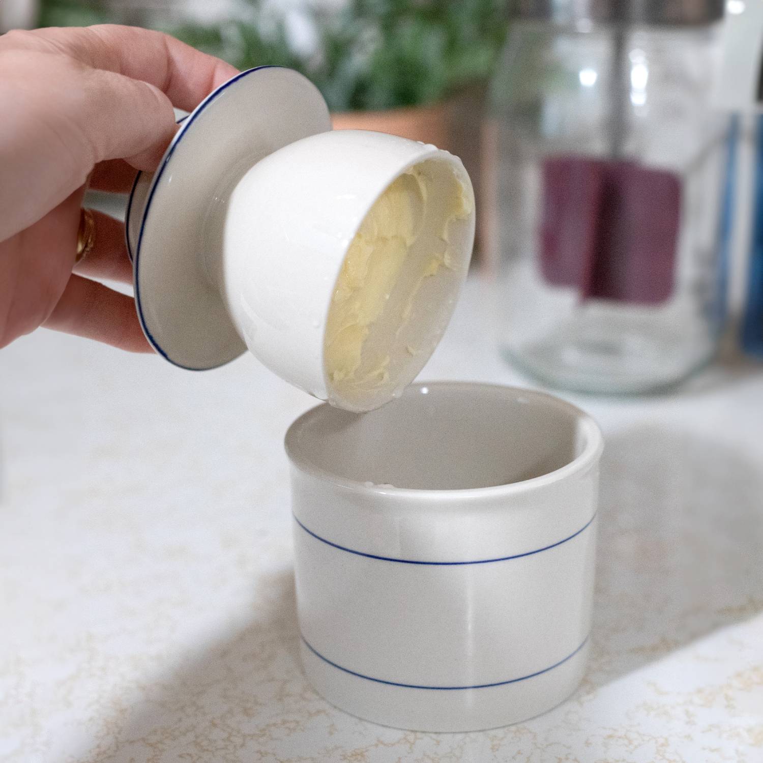 Cream stoneware butter keeper with blue line accents, ideal for kitchenware and under $50 kitchen accessory collections