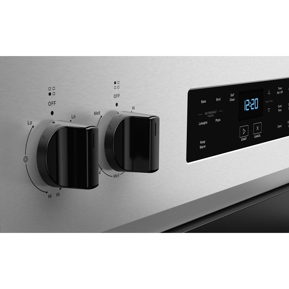 close-up of stainless steel electric range control panel with black knobs and digital timer display in appliances collection