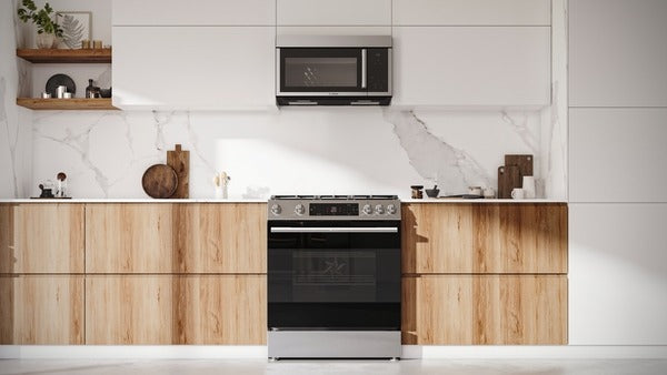 Stainless steel over-the-range microwave with left side-opening door installed above a modern electric stove in a minimalist kitchen setting, part of Bosch Appliances and Kitchen & Kitchenware collections.