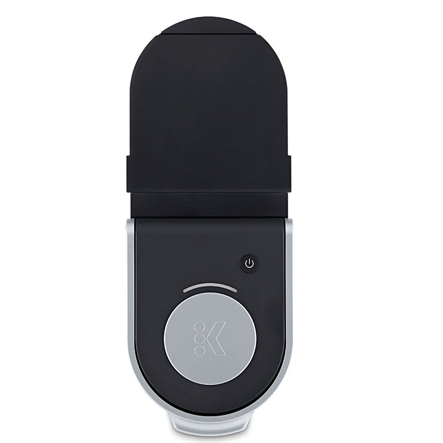 Top view of a sleek black single-serve coffee brewer with silver accents and a power button for quick use at home