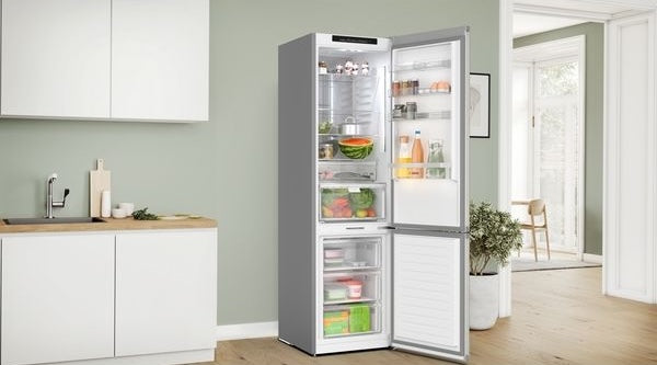 Freestanding stainless steel bottom freezer refrigerator with total no frost feature in modern kitchen appliances collection