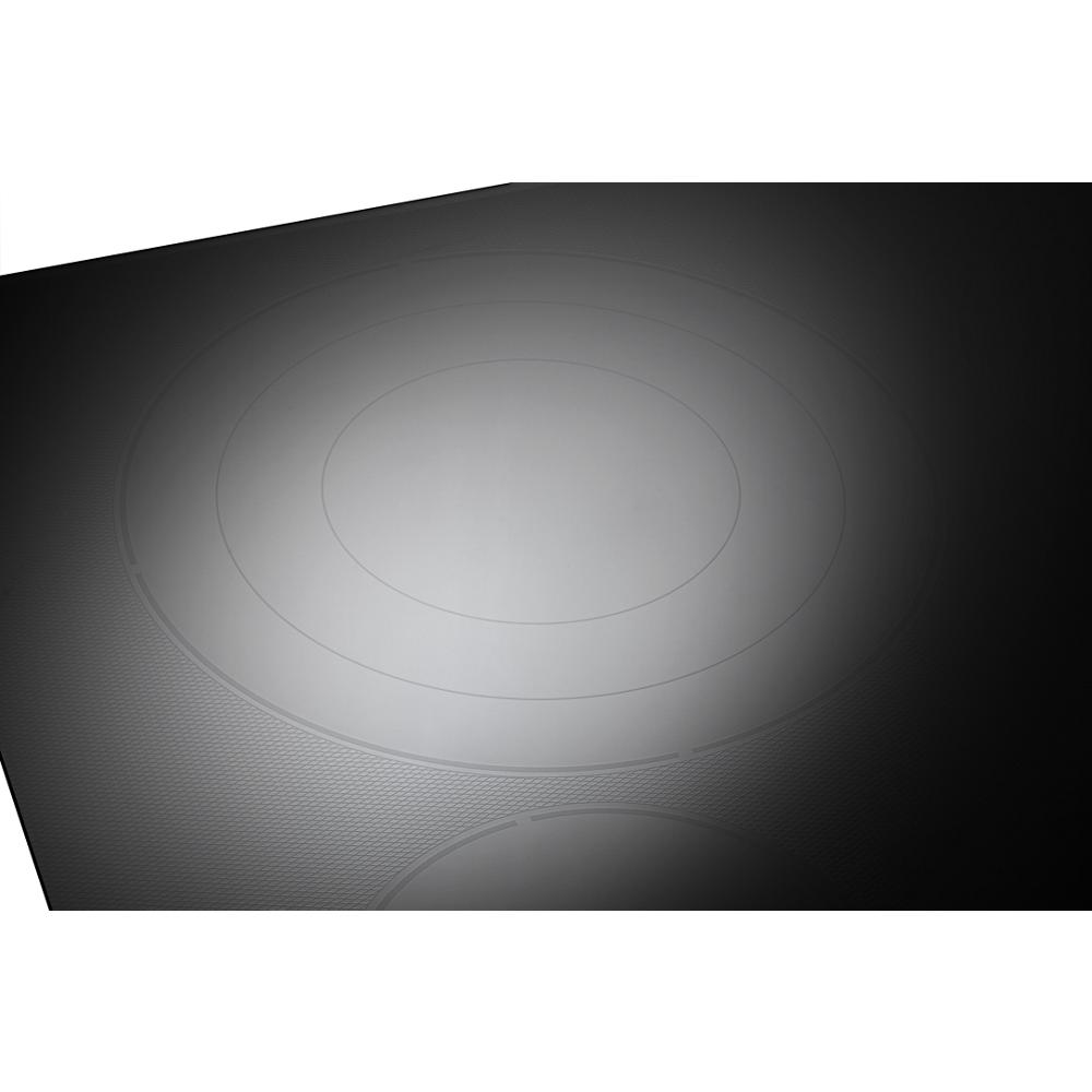 Black electric cooktop surface with radiant heating element and subtle concentric rings for kitchen appliances collection
