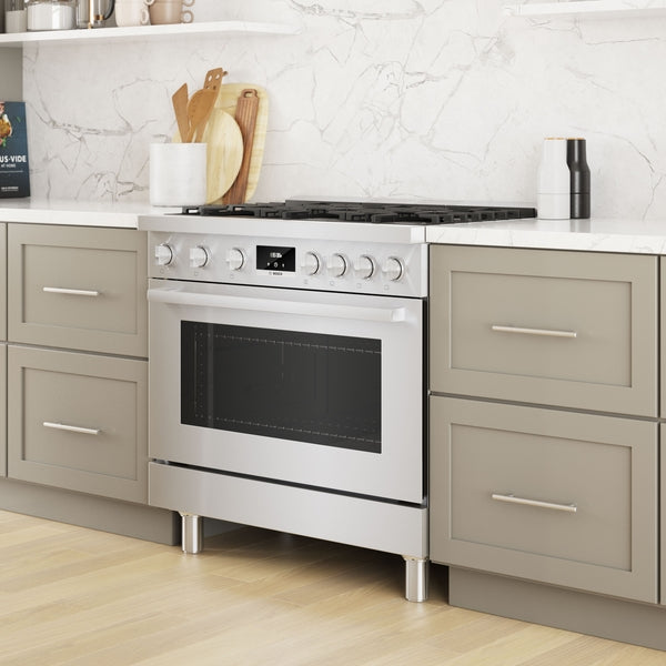 36-inch stainless steel dual fuel freestanding range with heavy-duty metal knobs in modern kitchen setting