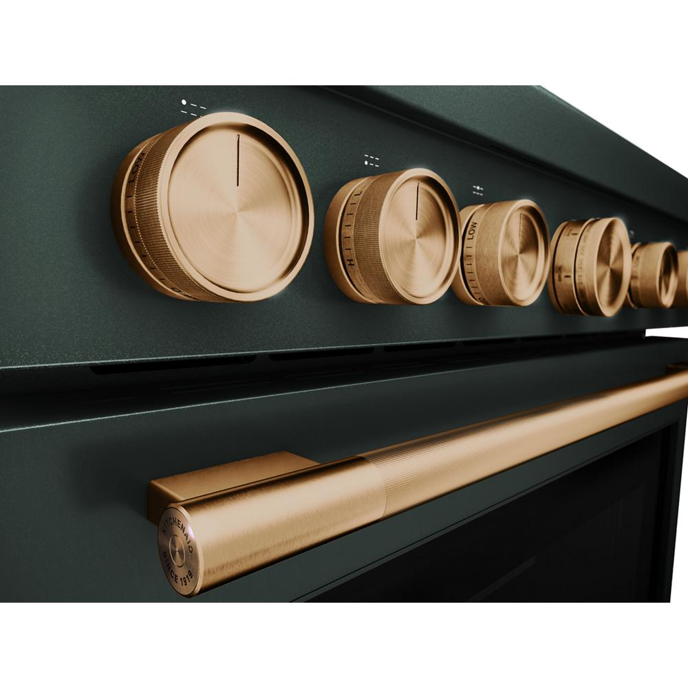 Close-up of green commercial-style range featuring six gold-toned control knobs and matching handle from KitchenAid collection