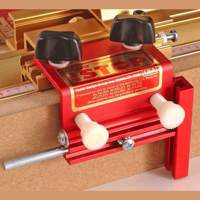 Red adjustable woodworking stop clamp with black knobs and metal rod, featured in hand and measuring tools under $100 collection