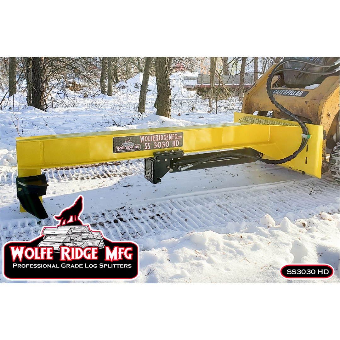 Yellow Wolfe Ridge SS 3030 HD log splitter attachment mounted on skid steer in snowy outdoor setting