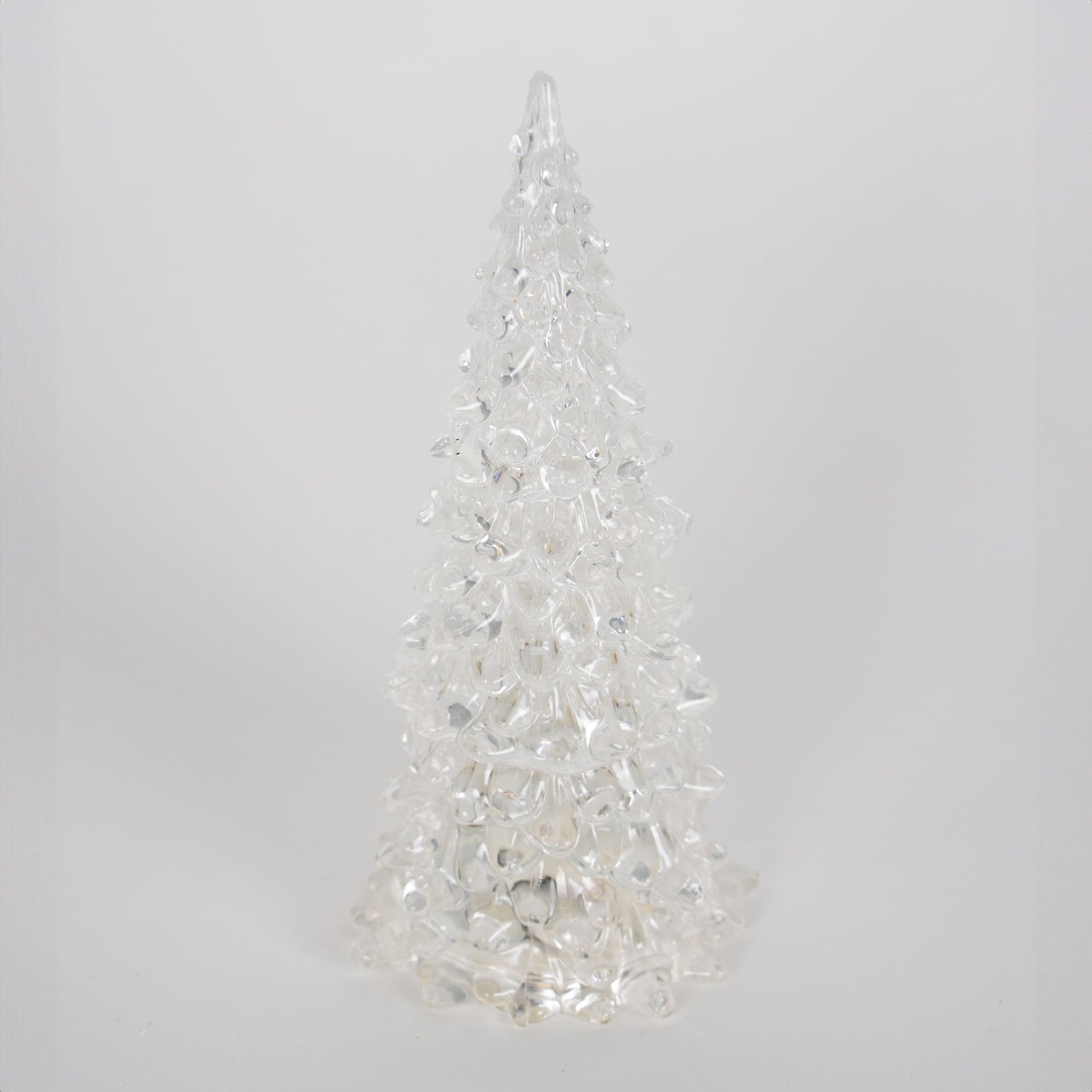 Single clear textured acrylic tree with embedded lights creating a delicate glowing effect for seasonal decor