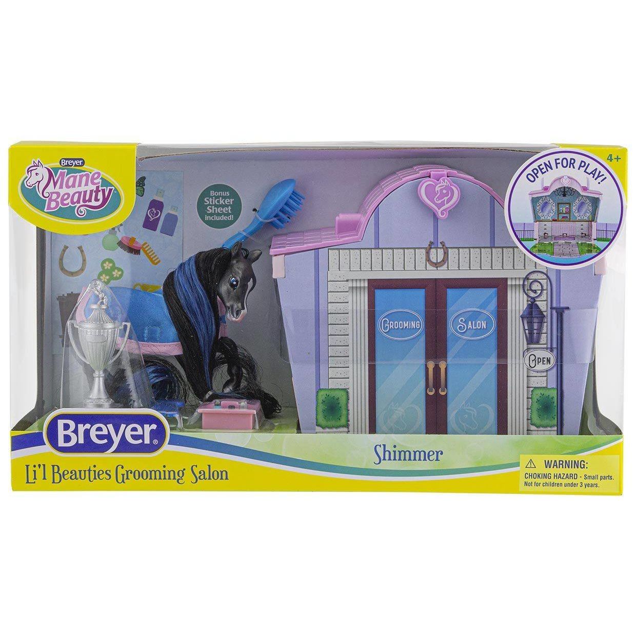 Miniature black horse figurine with blue mane next to purple and pink grooming salon playset with accessories
