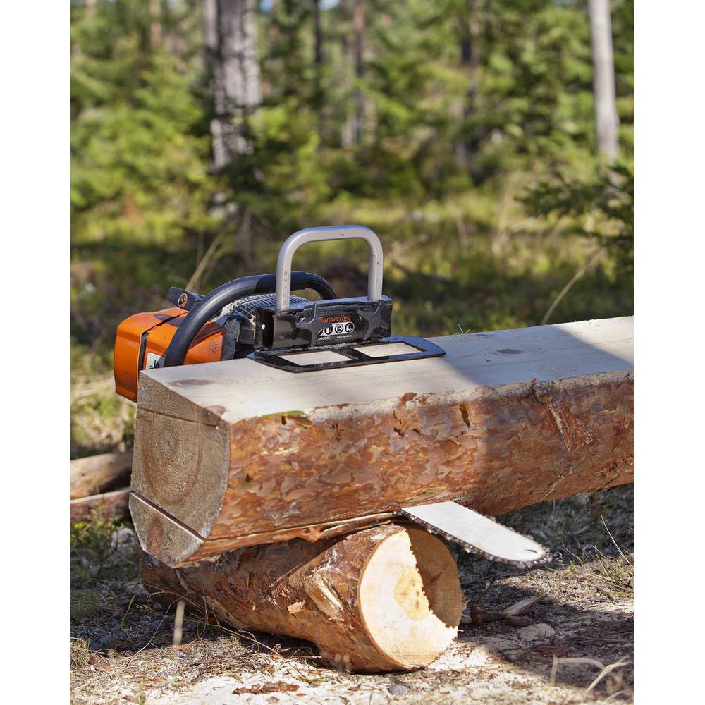 Portable timberjig with steel frame and orange handle positioned on large log for precise wood cutting outdoors
