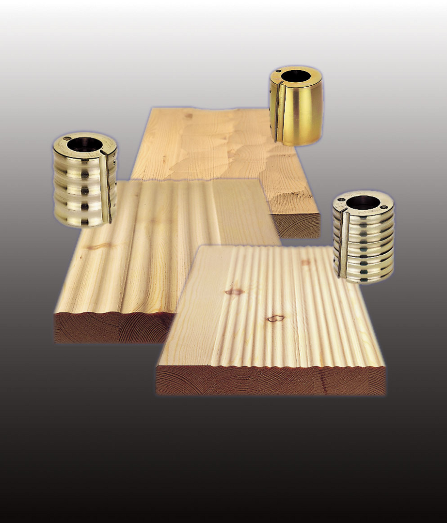 Three wooden boards with different grooved patterns demonstrating planer blade profiles for home improvement tools