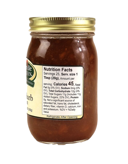 Glass jar of Hartville Kitchen rhubarb jam with gold lid and visible nutrition facts label in jams and jellies collection