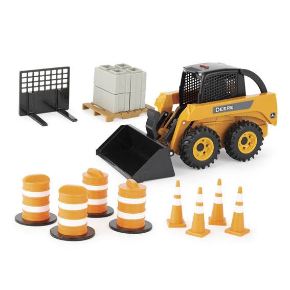 Yellow John Deere skid steer toy with black wheels, bucket attachment, traffic cones, and pallet of blocks for play use