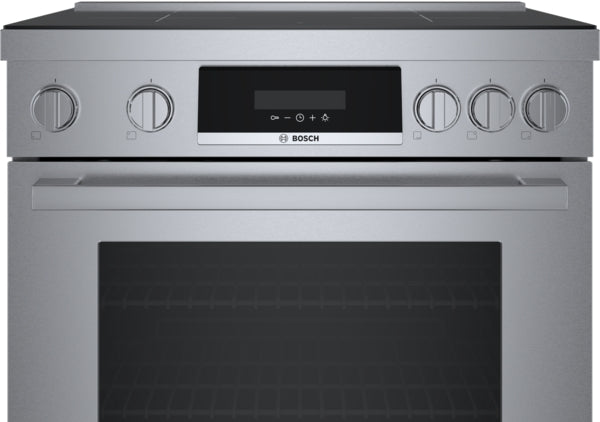 Front view of a stainless steel induction freestanding range with ergonomic tilted display and metal control knobs from Bosch collection