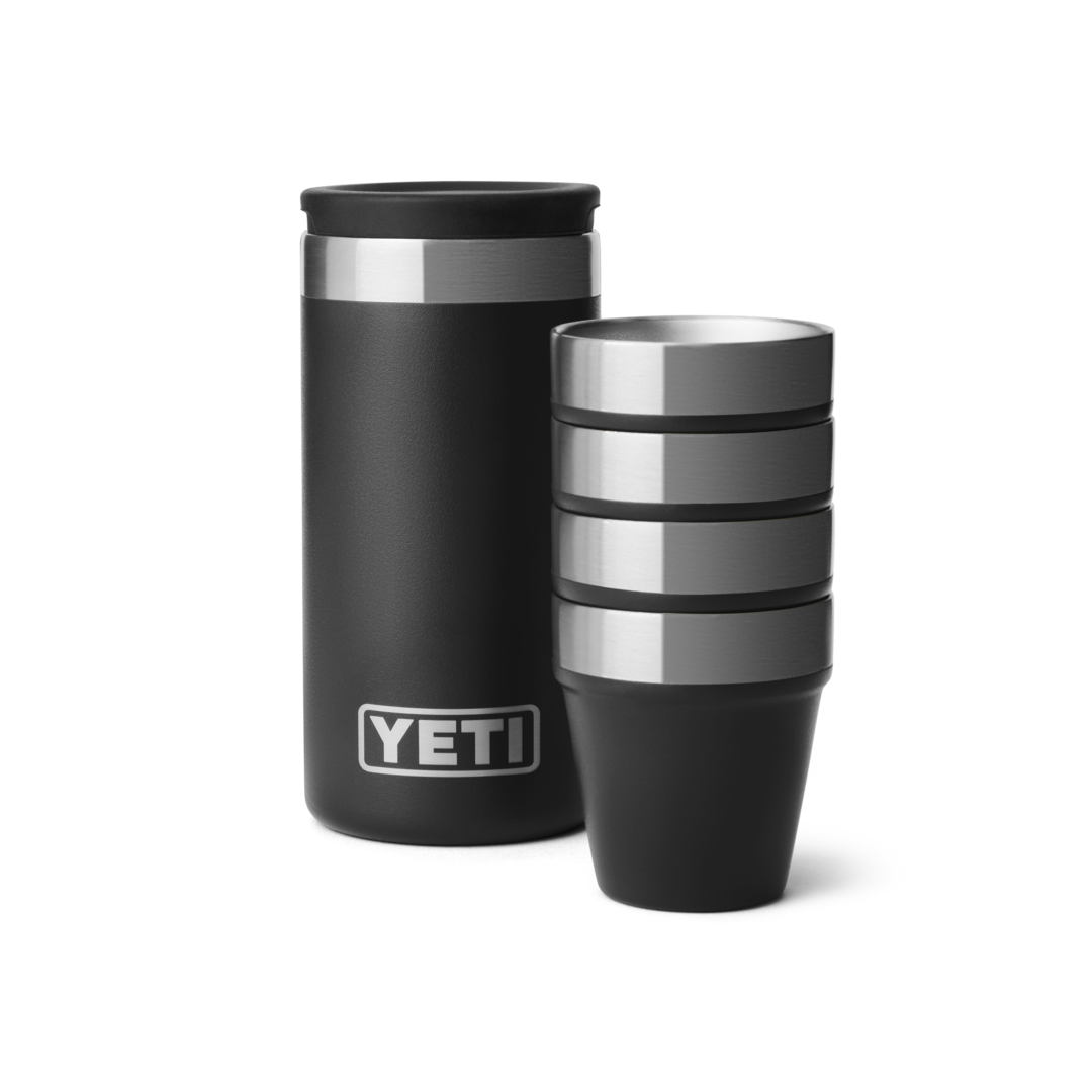 Durable black stainless steel shot glasses stacked next to a matching insulated carrying case for outdoor drinkware use