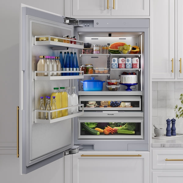 Built-in bottom freezer refrigerator with panel-ready design and organized interior in kitchen appliance collection